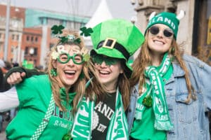 Dublin, Ireland - MAR 17: St. Patrick's Day, people with green hats and irish flags in Dublin city on March 17, 2019 in New Dublin, Ireland.