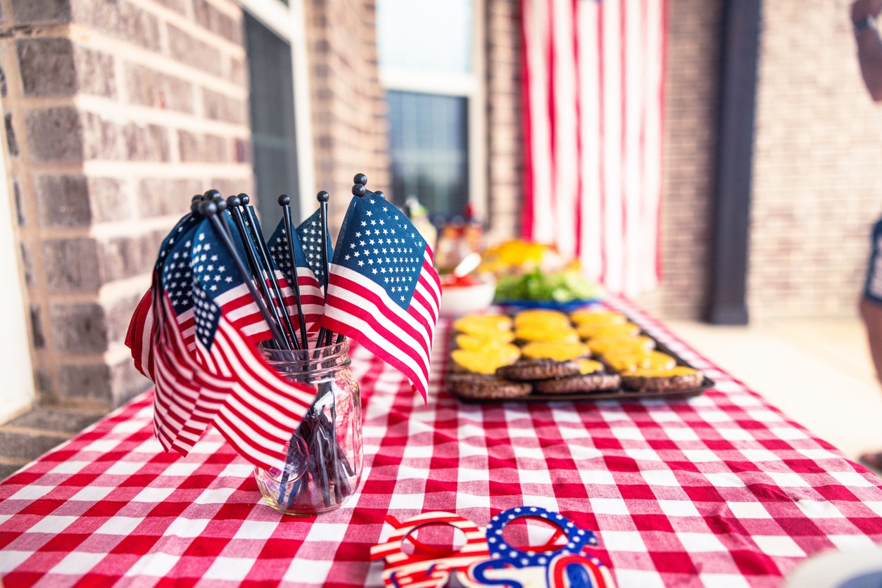 Fourth of July BBQ food spread on picnic table